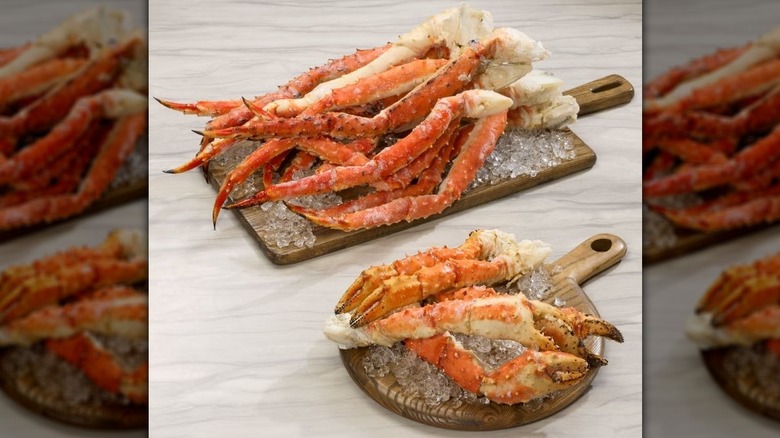 Red King Crab Legs on two small wooden boards