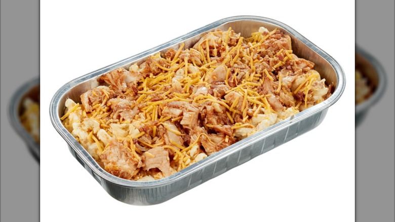Aluminum tray containing barbecue-flavored mac and cheese with bacon and chicken.