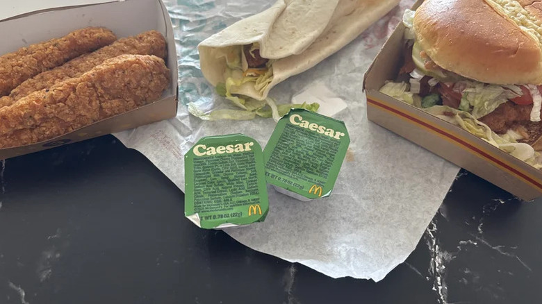 Two Caesar dipping sauces with chicken entrees from McDonald's