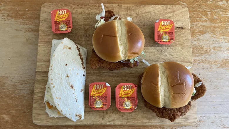 Chicken sandwiches from McDonald's with hot honey sauce containers