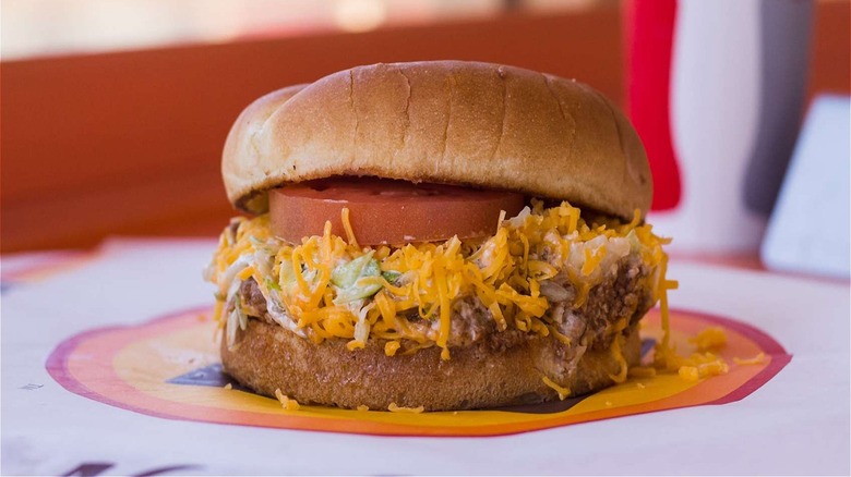 Naugles sandwich consisting of taco filling on burger a bun