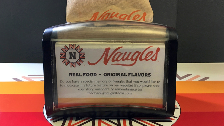 Napkin dispenser showing the Naugles branding