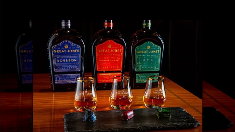 Great Jones whiskey bottles and pours