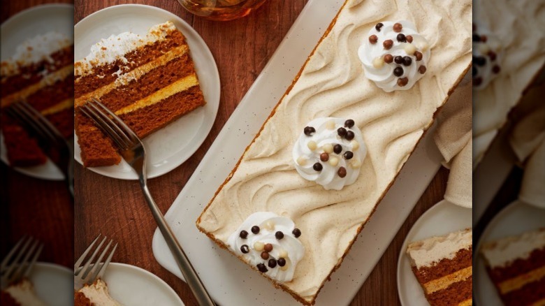 A pumpkin spice bar cake on plastic tray.