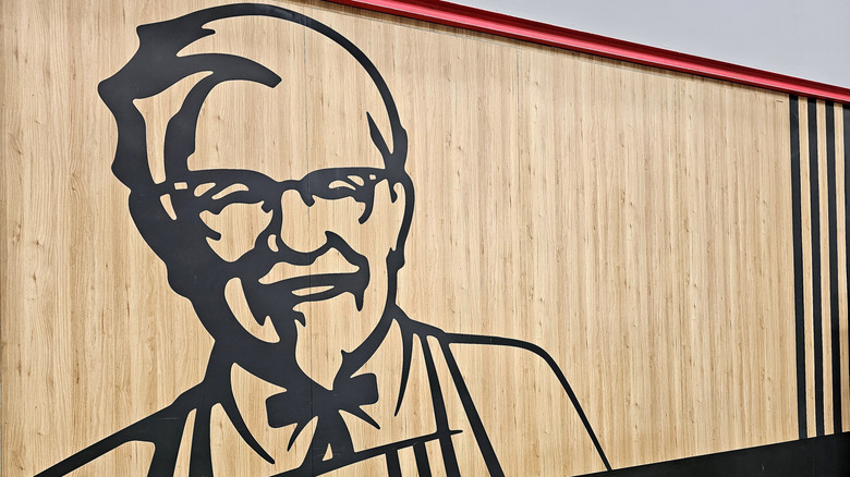 A wall stencil of Colonel Harland Sanders on a wooden wall