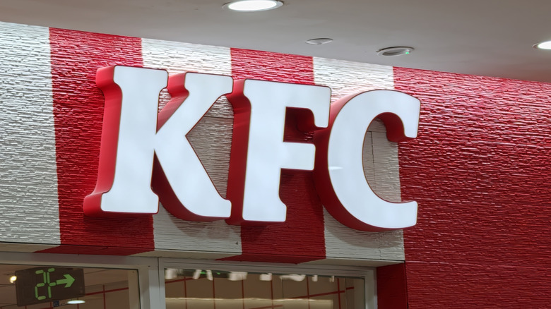 KFC signage against white and red stripes on storefront