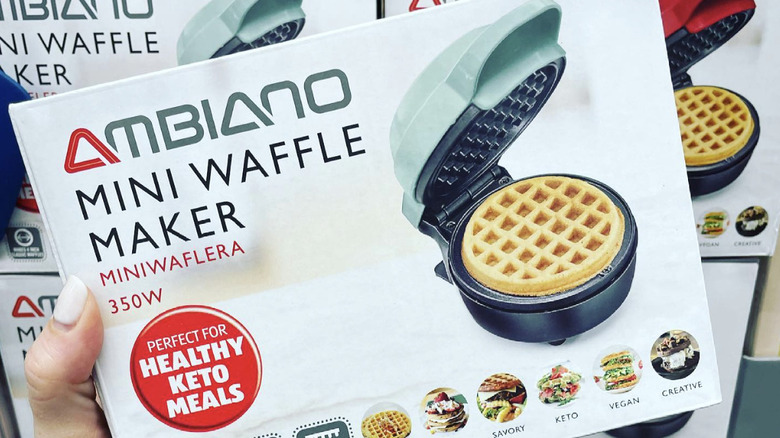 hand holding boxed Ambiano Mini Waffle Maker