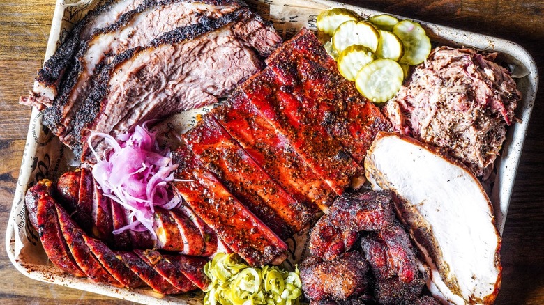 An overhead shot of a barbecue board with assorted meats and pickles from Wright's Barbecue