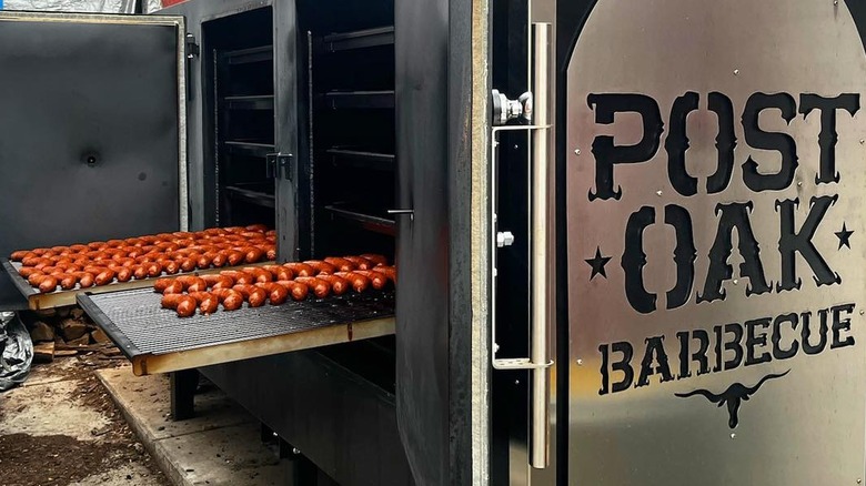 Sausages entering the Post Oak Barbecue smoker
