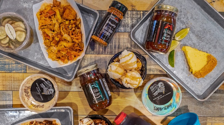 A collection of Big Hoffa's menu items, including barbecue, pickles, monster cookie, ice cream, pie, Big Hoffa's BBQ sauce and house seasoning