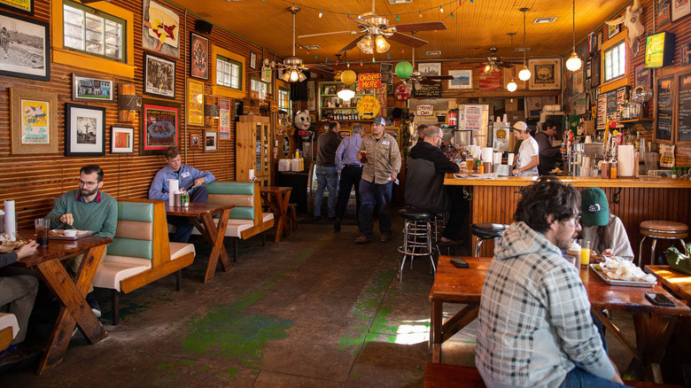 Guests eating inside The Joint near the bar