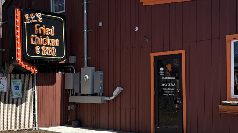A neon B.T.'s Fried Chicken & BBQ sign by the front door