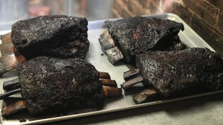 Four racks of ribs on a tray