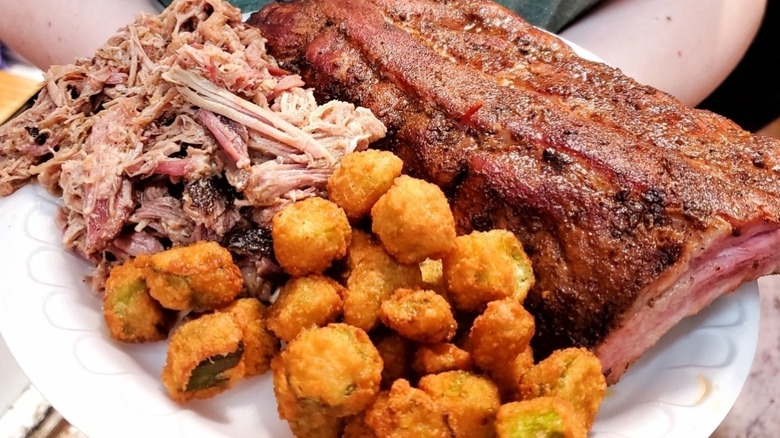 A plate with barbecue and fried okra