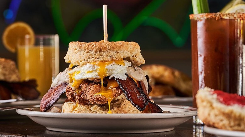 breakfast sandwich with chicken, along some drinks
