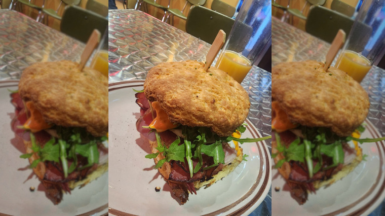 Loudpack breakfast sandwich with glass of oj