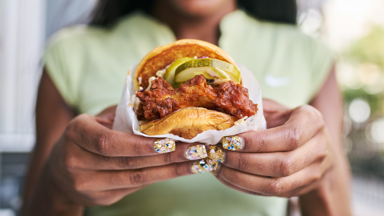 Woman holding burger