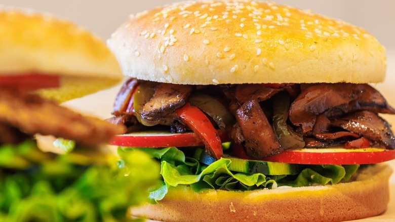 Close up of mushroom burger with apple and lettuce