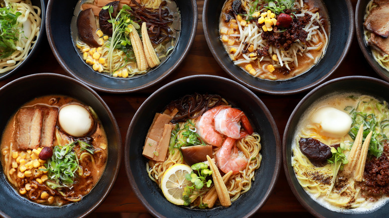 Bowls of ramen topped with pork, shrimp, and mushrooms