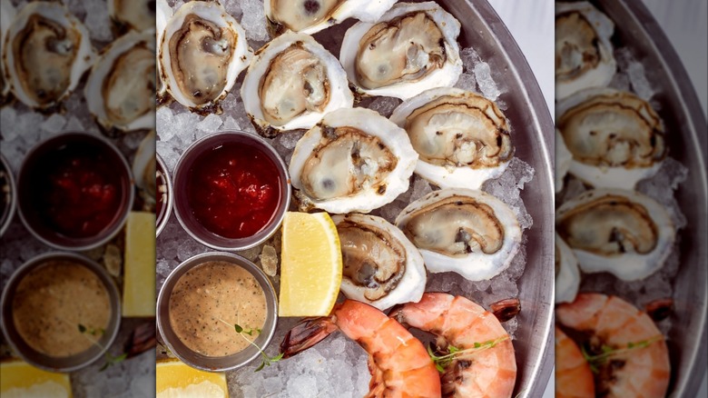 Seafood platter featuring oysters and shrimp on ice