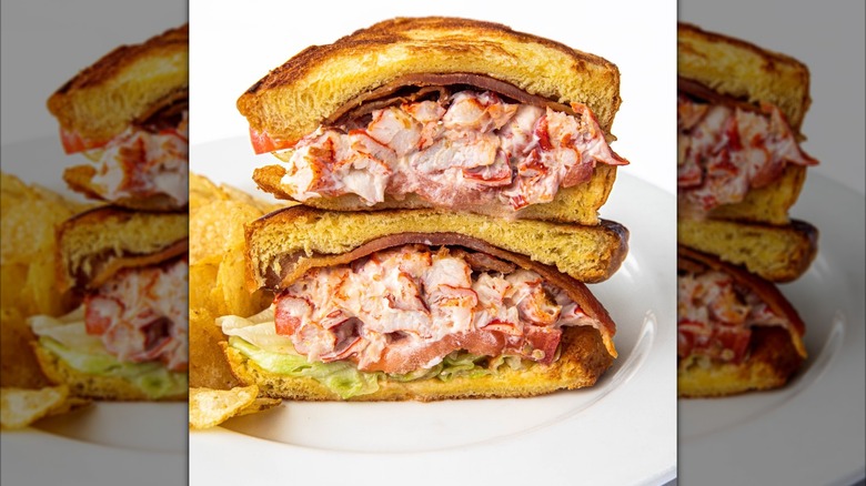 close-up of a lobster salad sandwich with bacon, tomato, and lettuce