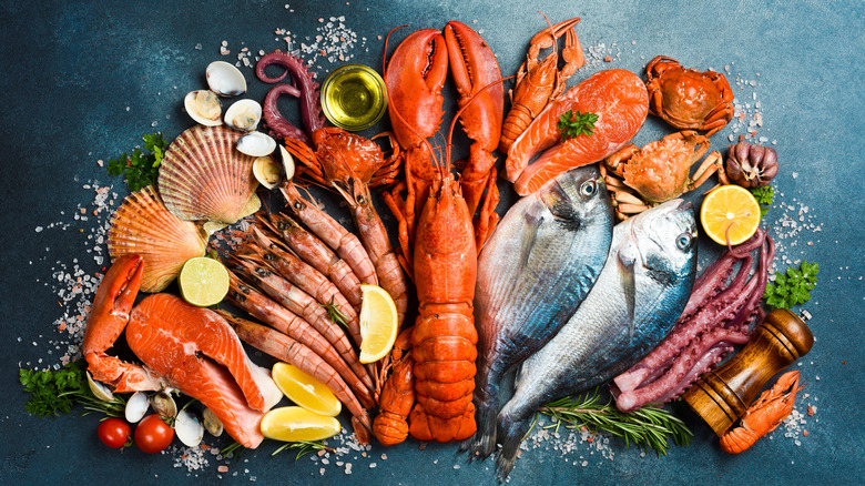 overhead stylized shot of a variety of seafood with lemons and herbs