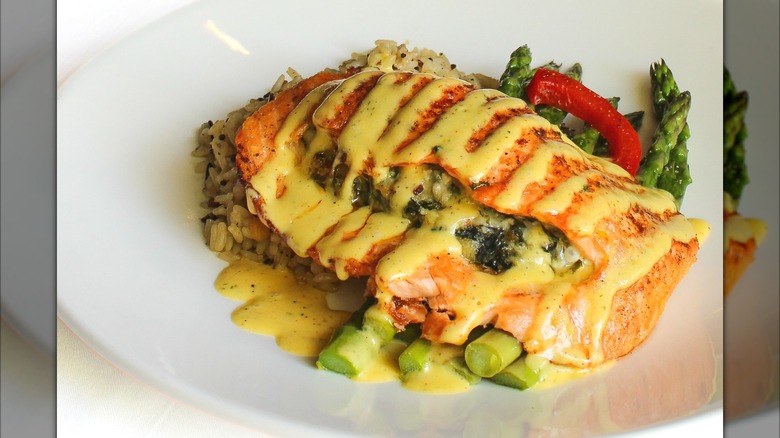 Stuffed salmon plated nicely with rice and asparagus