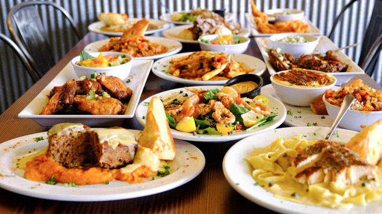 A dining table covered with an assortment of plated dishes