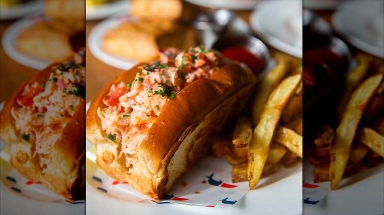 close-up of a lobster roll with fries on a plate