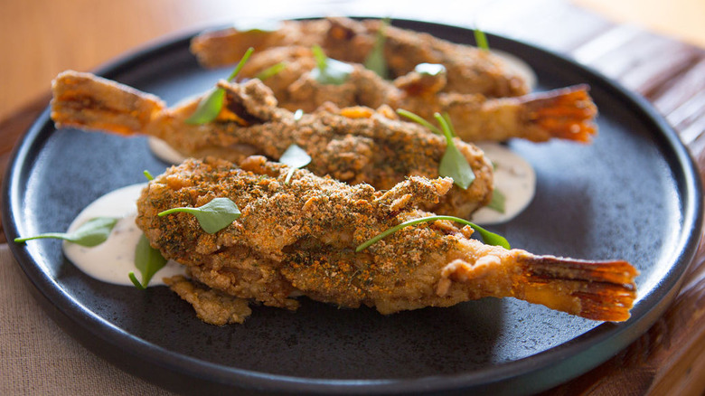 A composed dish at Alewife featuring small fried fish over sauce