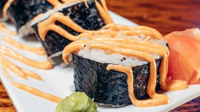 A sushi roll sliced and drizzled with sauce at Shuckers St Albans