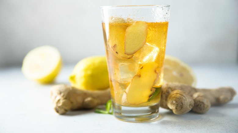 A glass of ginger ale with ginger roots