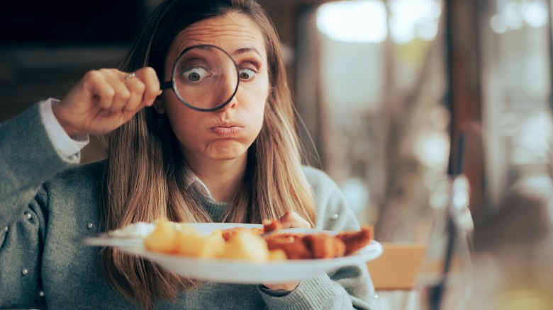 Examining meal with magnifying glass 