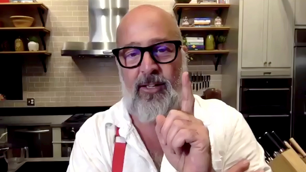 bearded Andrew Zimmern pointing