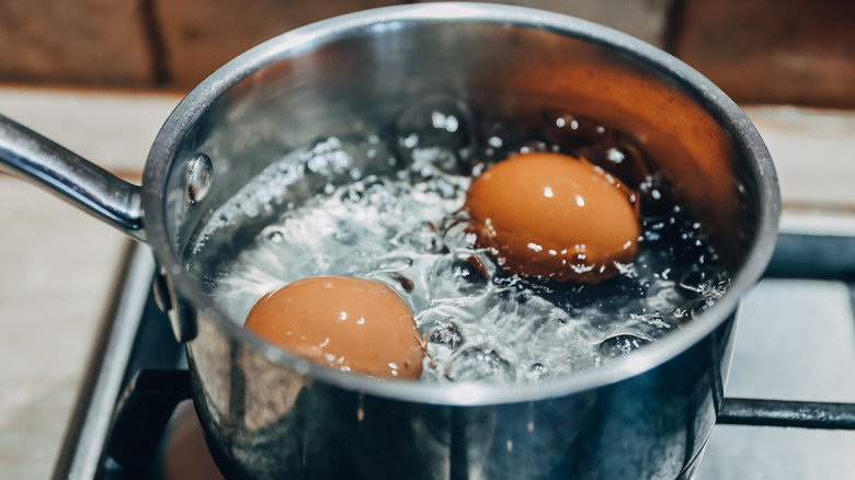 Eggs boiling in saucepan