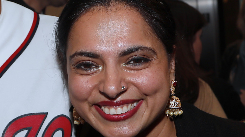 Maneet Chauhan wearing earrings and red lipstick