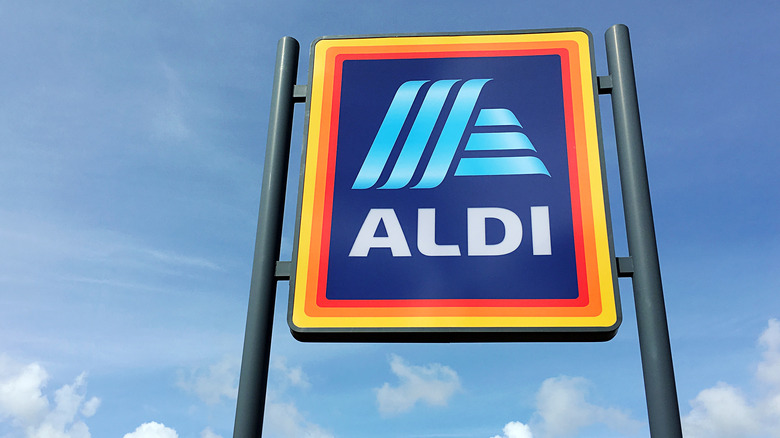 Aldi sign in front of a blue sky