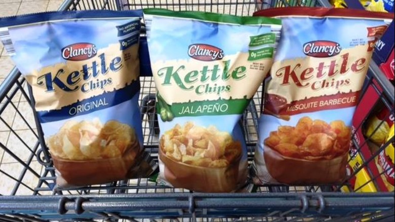 An assortment of chips from Aldi in a grocery cart