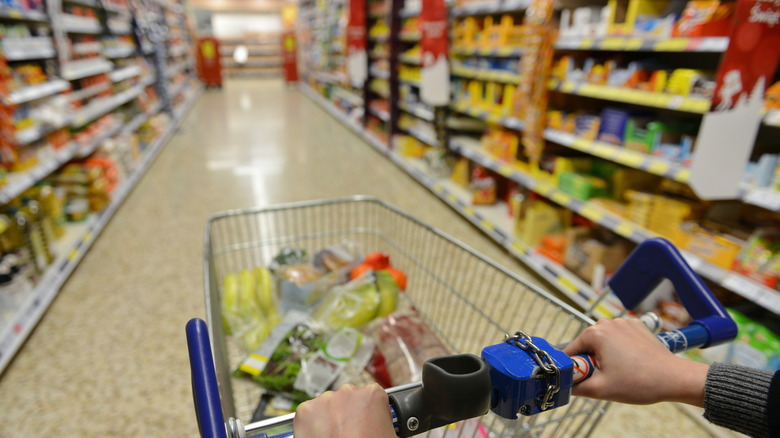 Grocery cart in Aldi store aisle