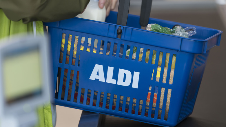 shopper holding Aldi shopping basket