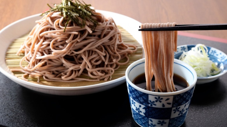 chopsticks lifting soba noodles