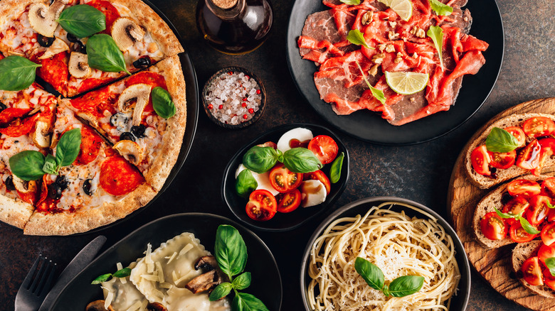 table of Italian food with pizza and pasta