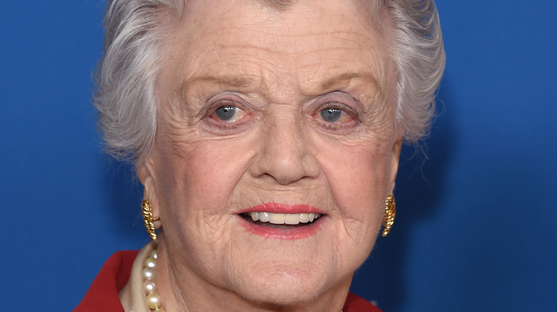 Head shot of Angela Lansbury wearing gold earrings. 