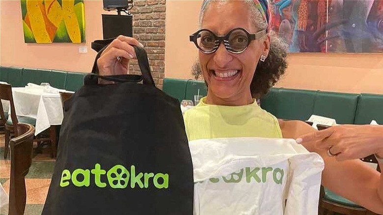 Carla Hall holding EatOkra merch