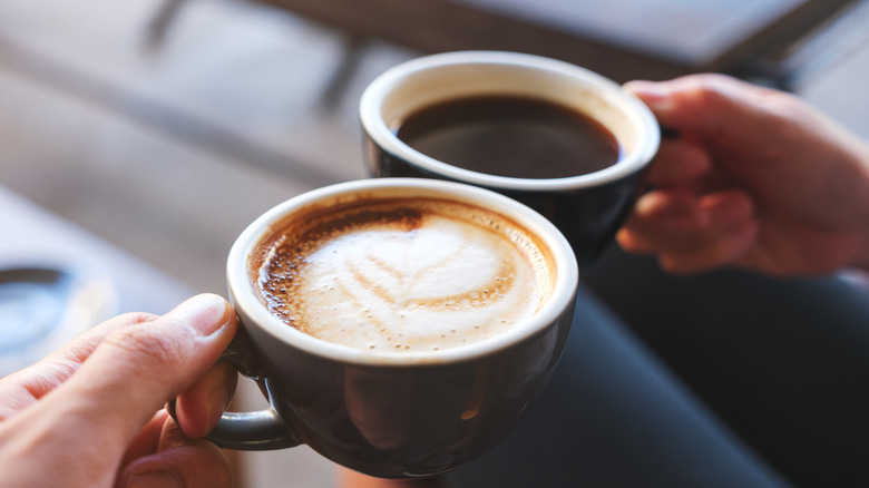 Hands holding cups of coffee