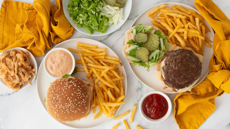 McDonald's Big Arch burgers on plates with fries and sauces