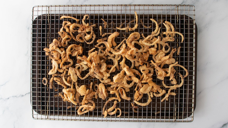Crispy fried onions on wire rack
