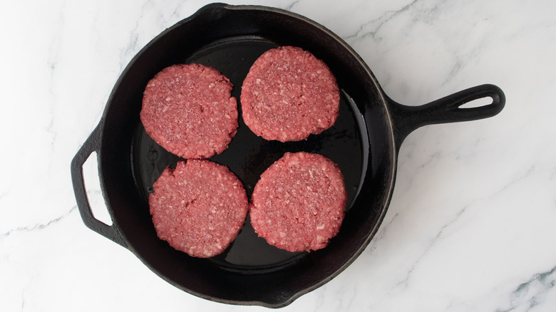 Burger patties in skillet