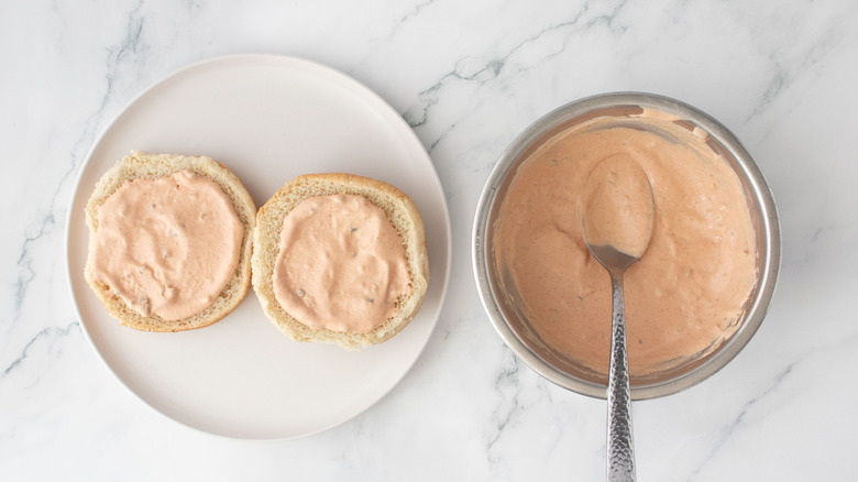 Buns with sauce next to sauce in bowl