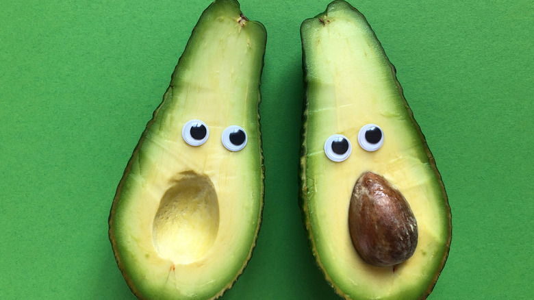 Avocados with faces and googly eyes